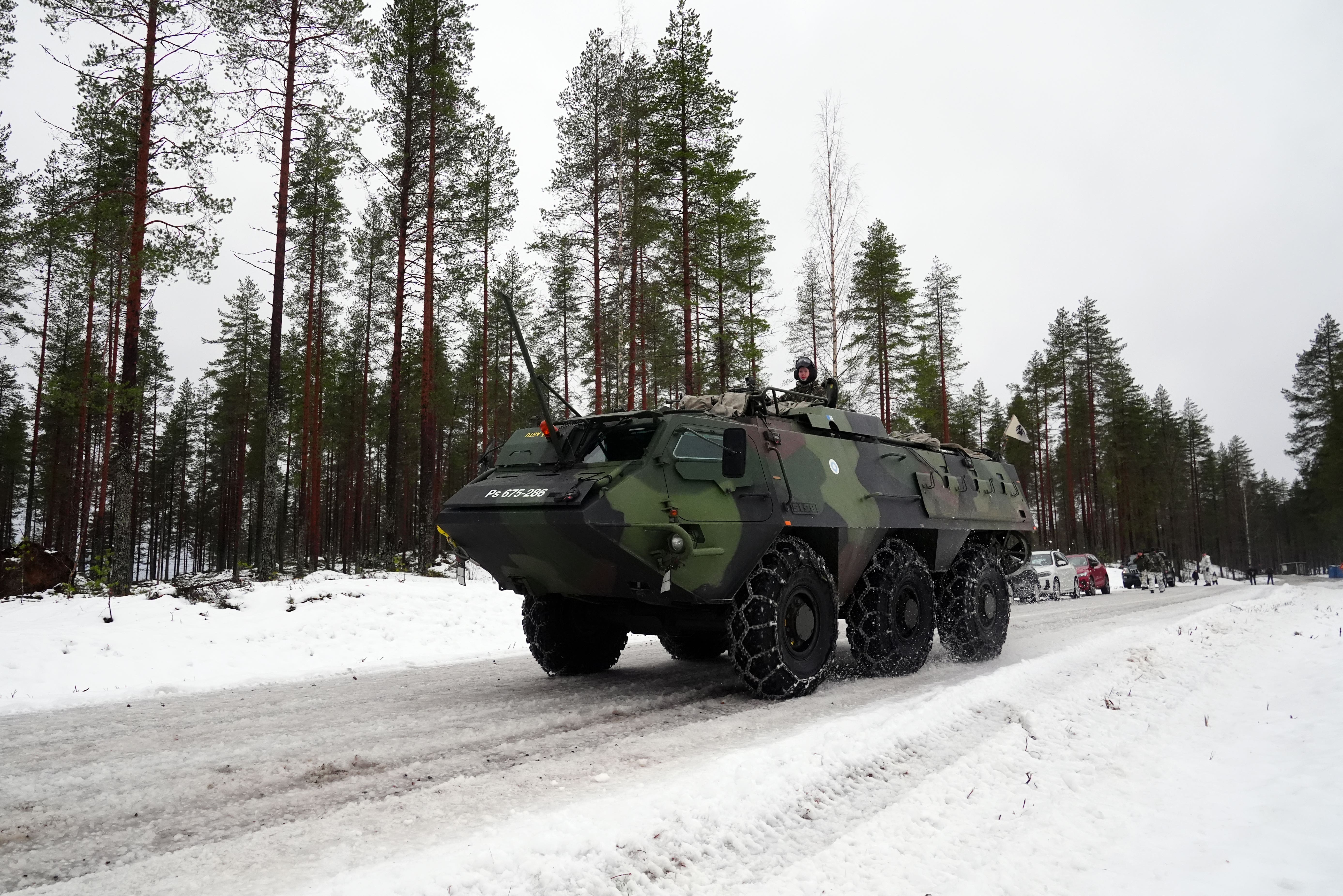 Members of the Finnish army and British Army in an armoured vehicle during a major Nato training exercise on the border with Russia