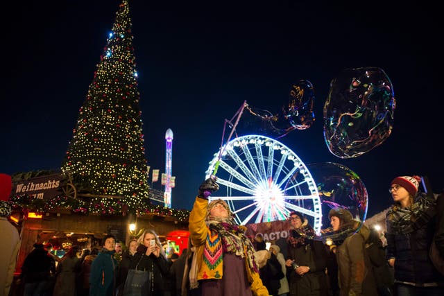 Visitors enjoy the rides and sights at Hyde Park Winter Wonderland in London (Ben Stevens/PA)