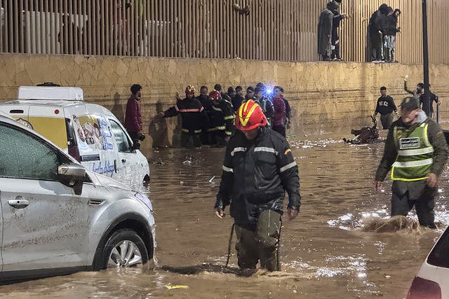 <p>People wade through a street after a flash flood in Safi on December 14, 2025</p>