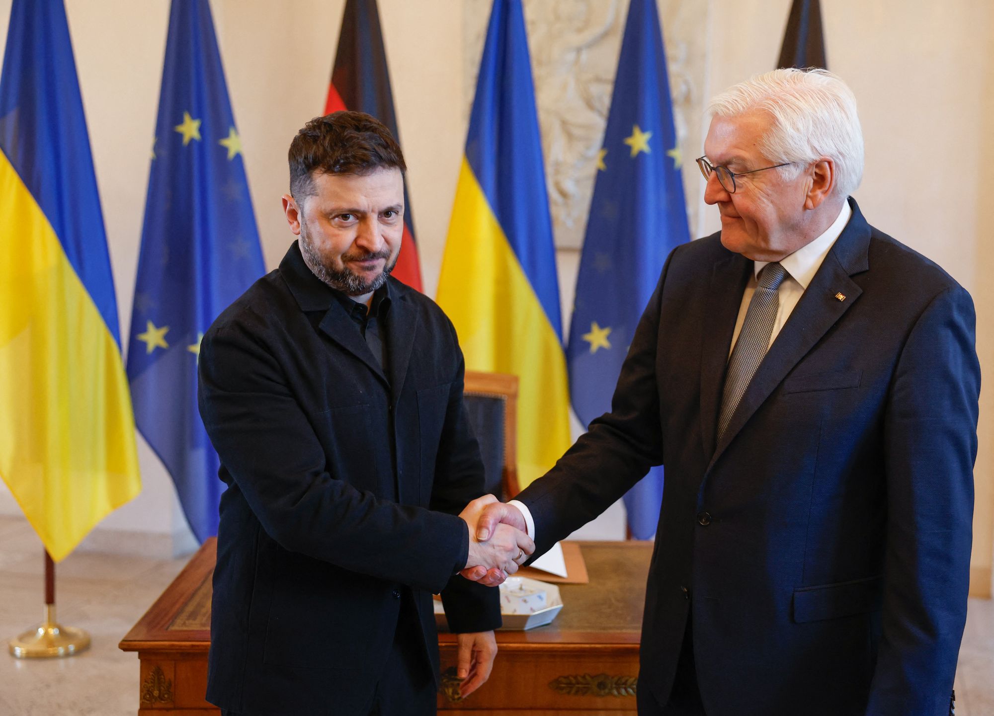 <p>German President Frank-Walter Steinmeier and Ukraine's President Volodymyr Zelensky (R) shake hands before signing the guestbook at the presidential Bellevue Palace in Berlin, Germany, on December 15, 2025. Ukrainian President Volodymyr Zelensky was set to push on with talks in Berlin with US President Donald Trump's envoys on how to end the grinding war with Russia. (Photo by Odd ANDERSEN / AFP via Getty Images)</p>