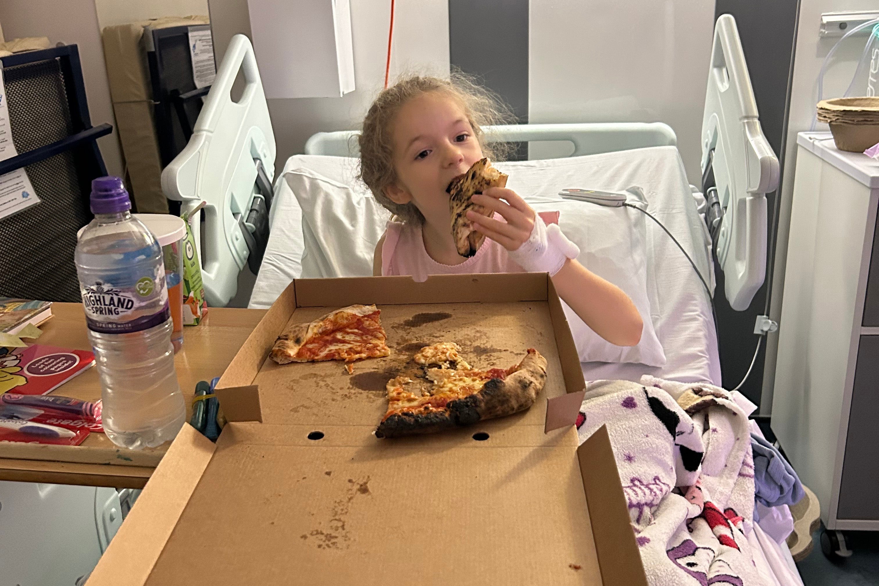 Liberty enjoying a pizza party after her operation