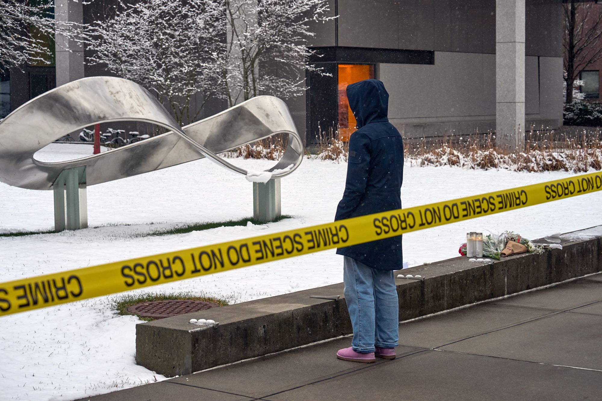 <p>A person mourns at a makeshift memorial outside the Barus & Holley engineering building on the campus of Brown University, in Providence, Rhode Island on December 14, 2025</p>