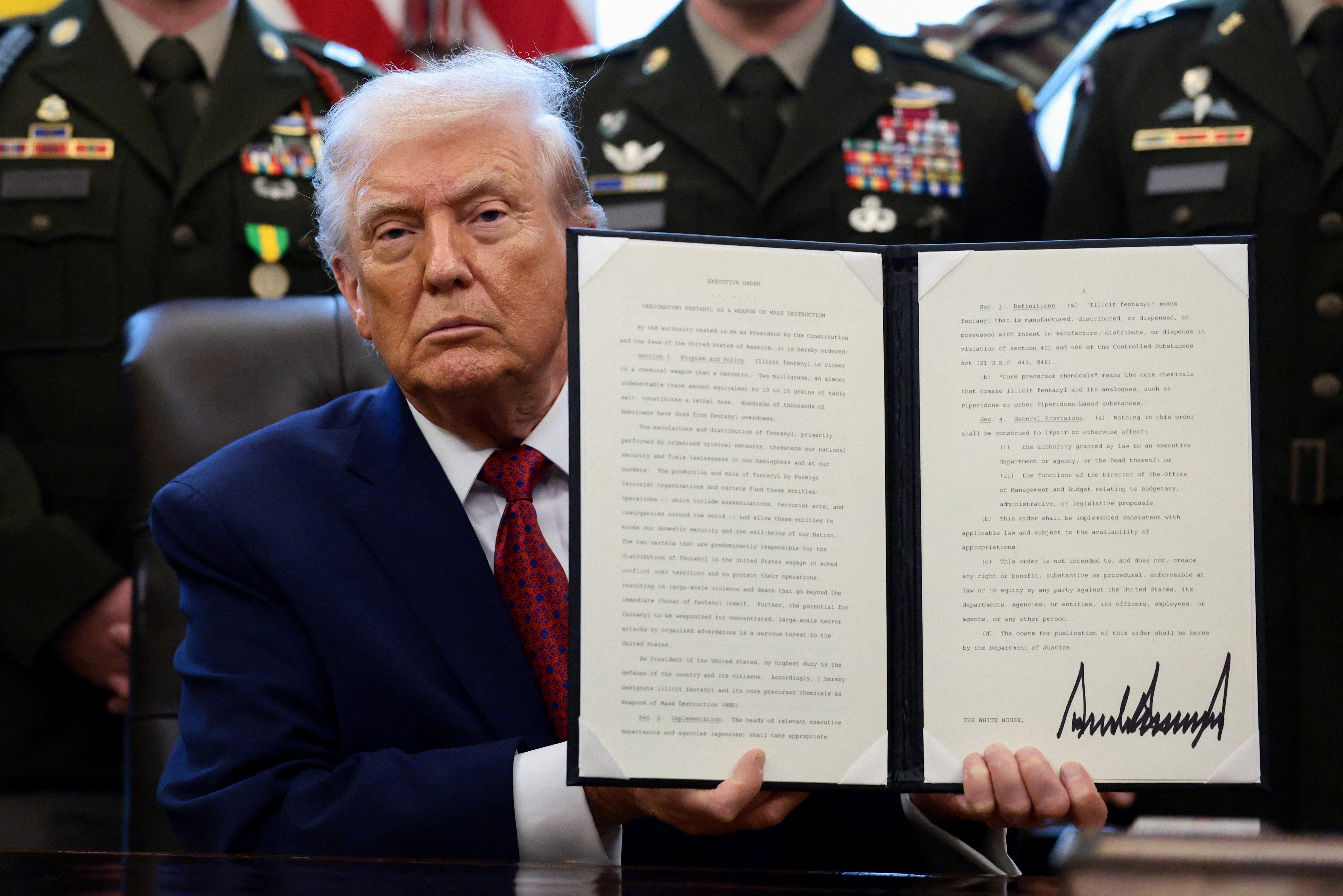 <p>President Donald Trump shows a signed executive order classifying fentanyl as 'weapon of mass destruction' during an Oval Office event. </p>