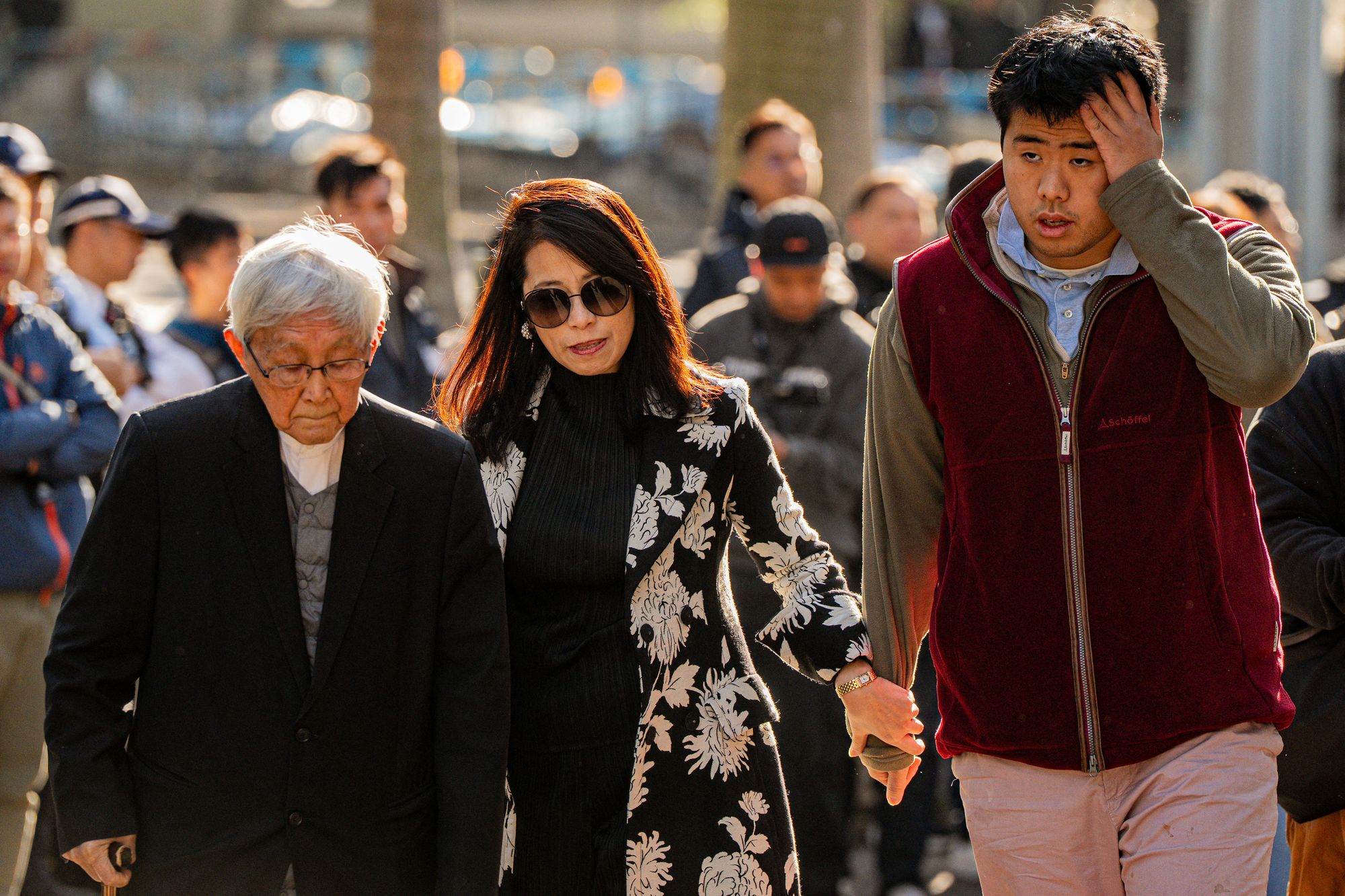 Teresa Lai, centre, and Lai Shun-yan, right, wife and son of Jimmy Lai arrive to hear the verdict in his trial in Hong Kong