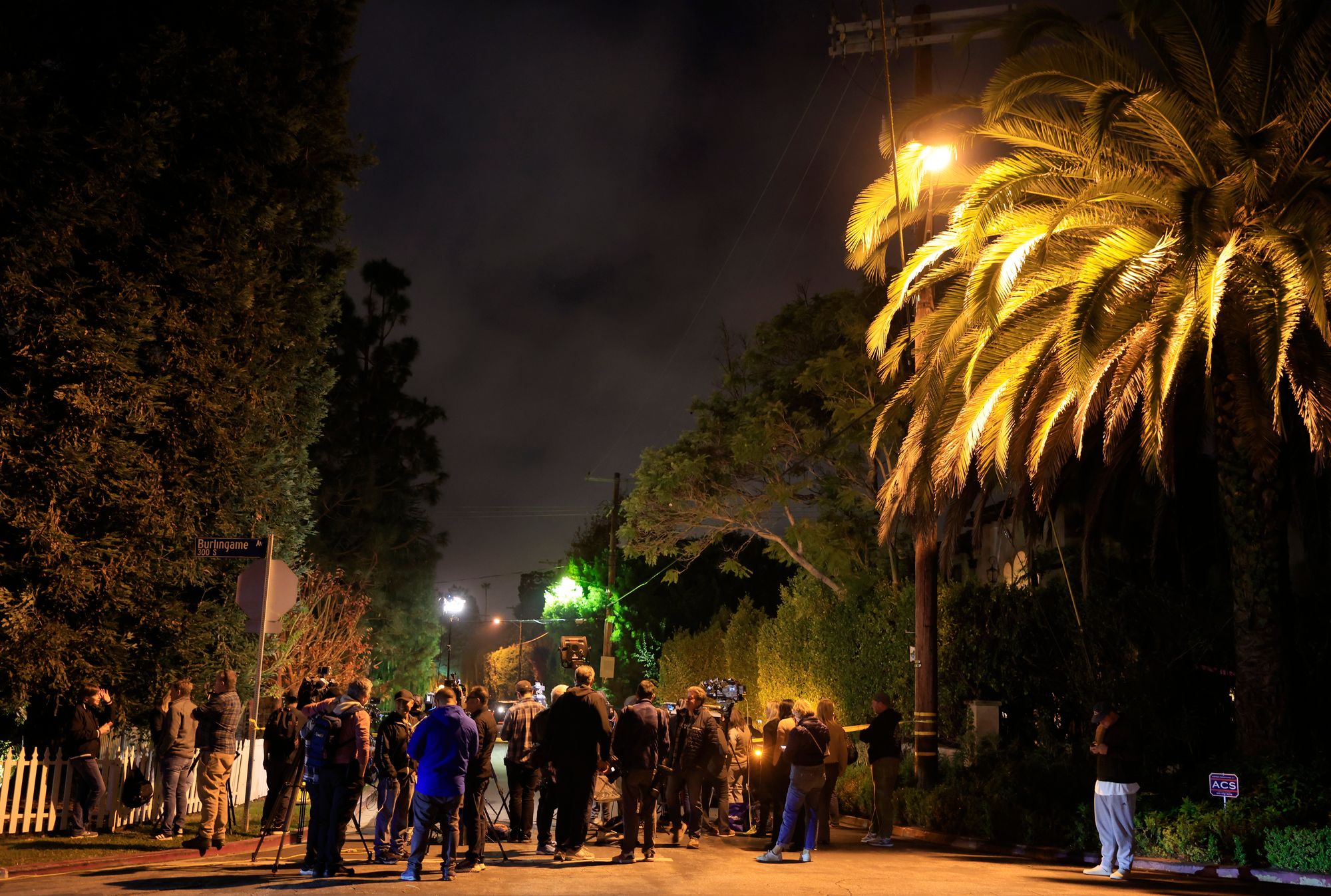 Police, media and neighbors outside the Reiners’ home in Brentwood, Los Angeles, on Sunday evening