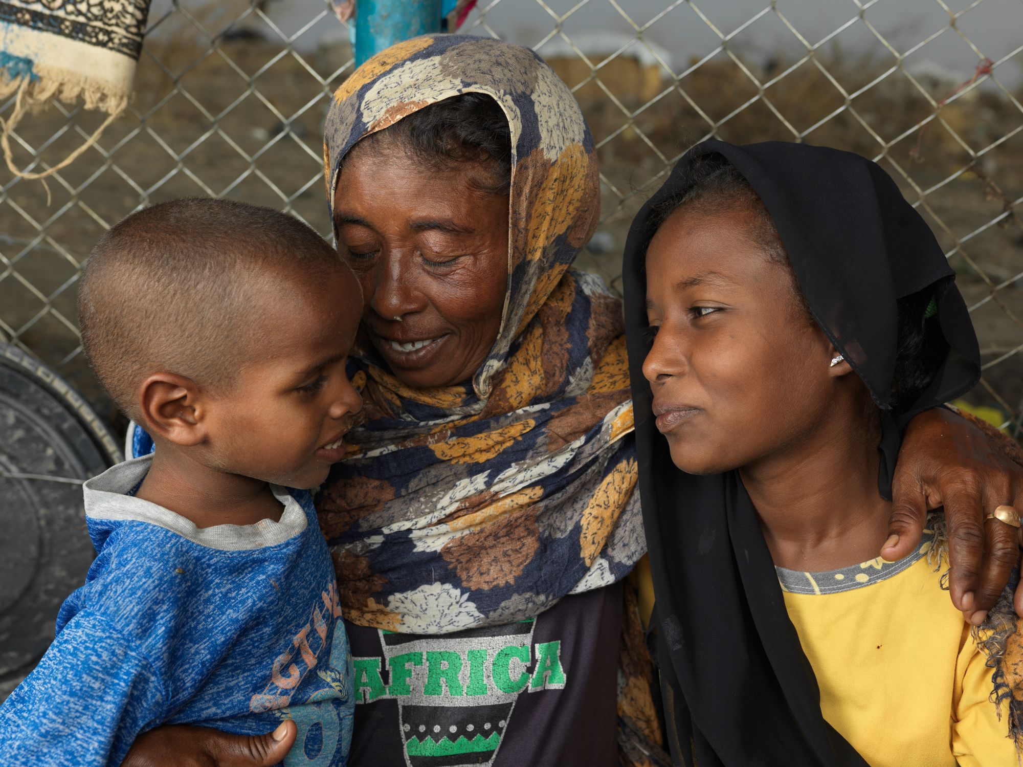 Saud Yosif Idris Mahmou, 40, and her children Asia and Hassan, at their shelter at the transit center in Renk