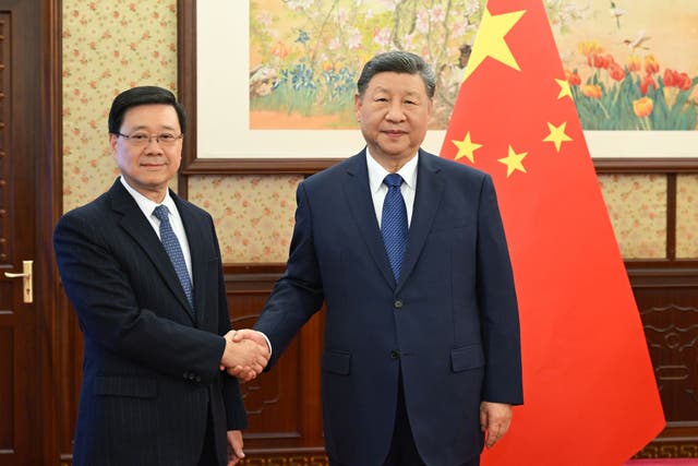 <p>Hong Kong chief executive John Lee, left, shakes hands with Chinese president Xi Jinping </p>