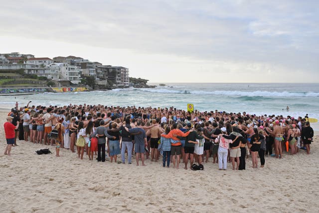 <p>Swimmers gather for a morning vigil following the shooting at Bondi Beach in Sydney</p>
