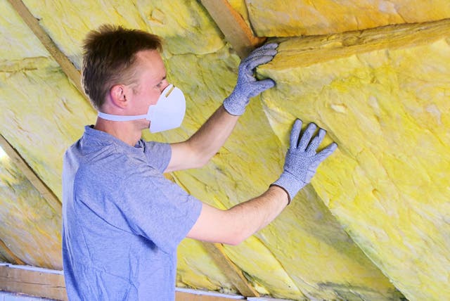 <p>A builder installing insulation.</p>
