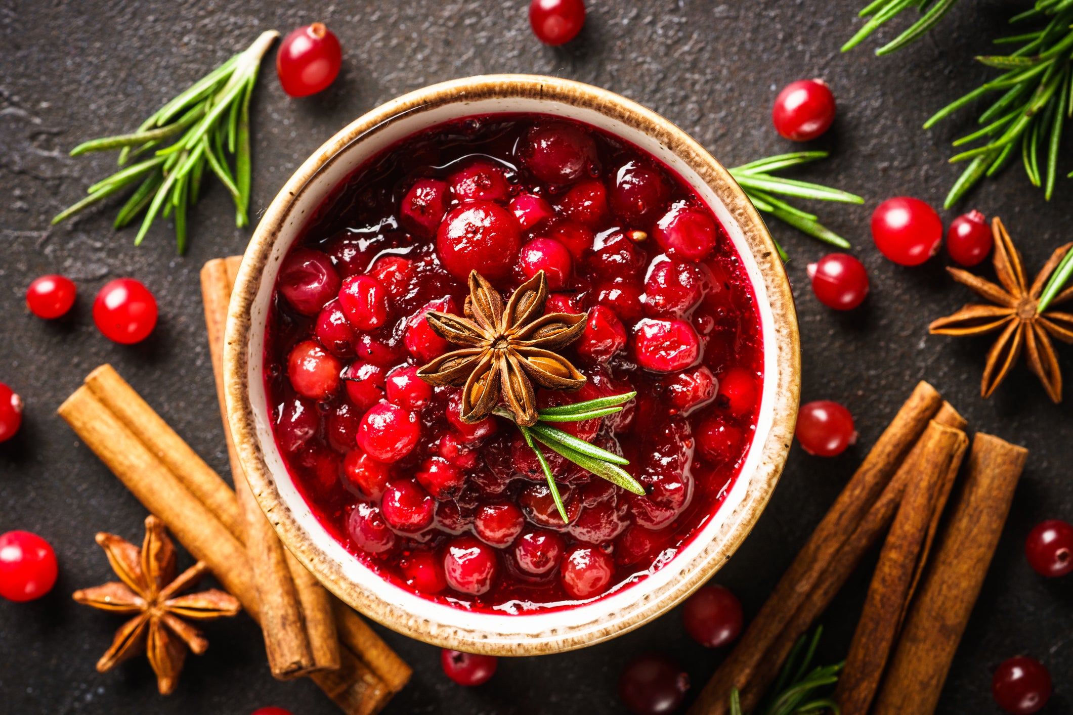 <p>Cranberry sauce in a bowl with rosemary and spices</p>