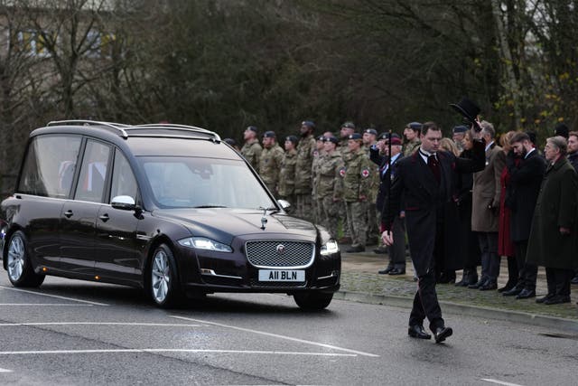 The cortege carrying the body of Lance Corporal George Hooley passes the Memorial Garden in Carterton, West Oxfordshire, following his repatriation into RAF Brize Norton (Ben Whitley/PA)