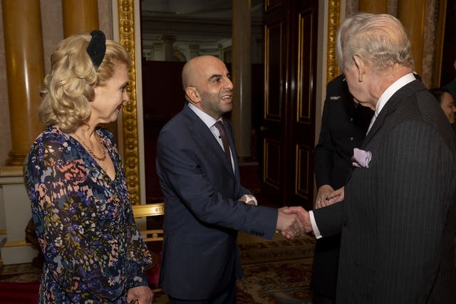 The King greets Samir Zitouni and his wife Eleni Sakkoulei during a reception at Buckingham Palace (Aaron Chown/PA)