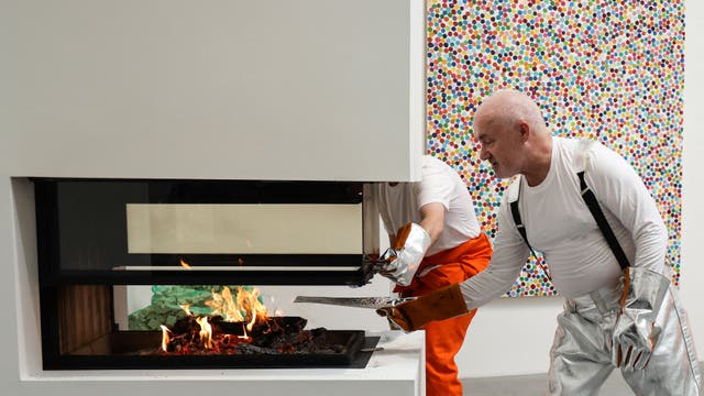 <p>British artist Damien Hirst burns an art piece at London's Newport Street Gallery in October 2022 as part of his exhibition 'The Currency'. The concept: after selling NFTs for thousands of his paintings, he then methodically burned the originals.</p>