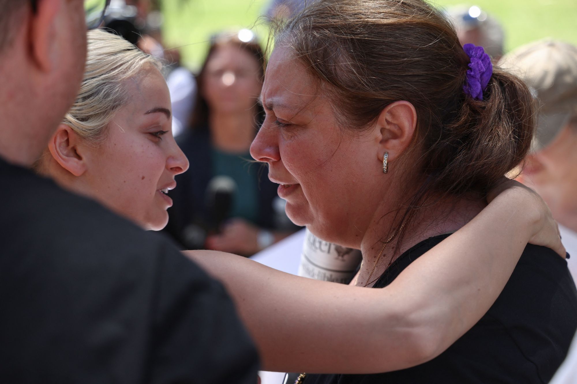 A woman consoles Valentyna (R), mother of 10-year-old Matilda, who was killed in the Bondi Beach attack
