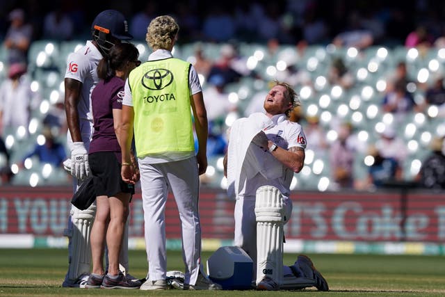 <p>Ben Stokes (right) tries to cool himself down with a towel while batting in hot temperatures on day two</p>