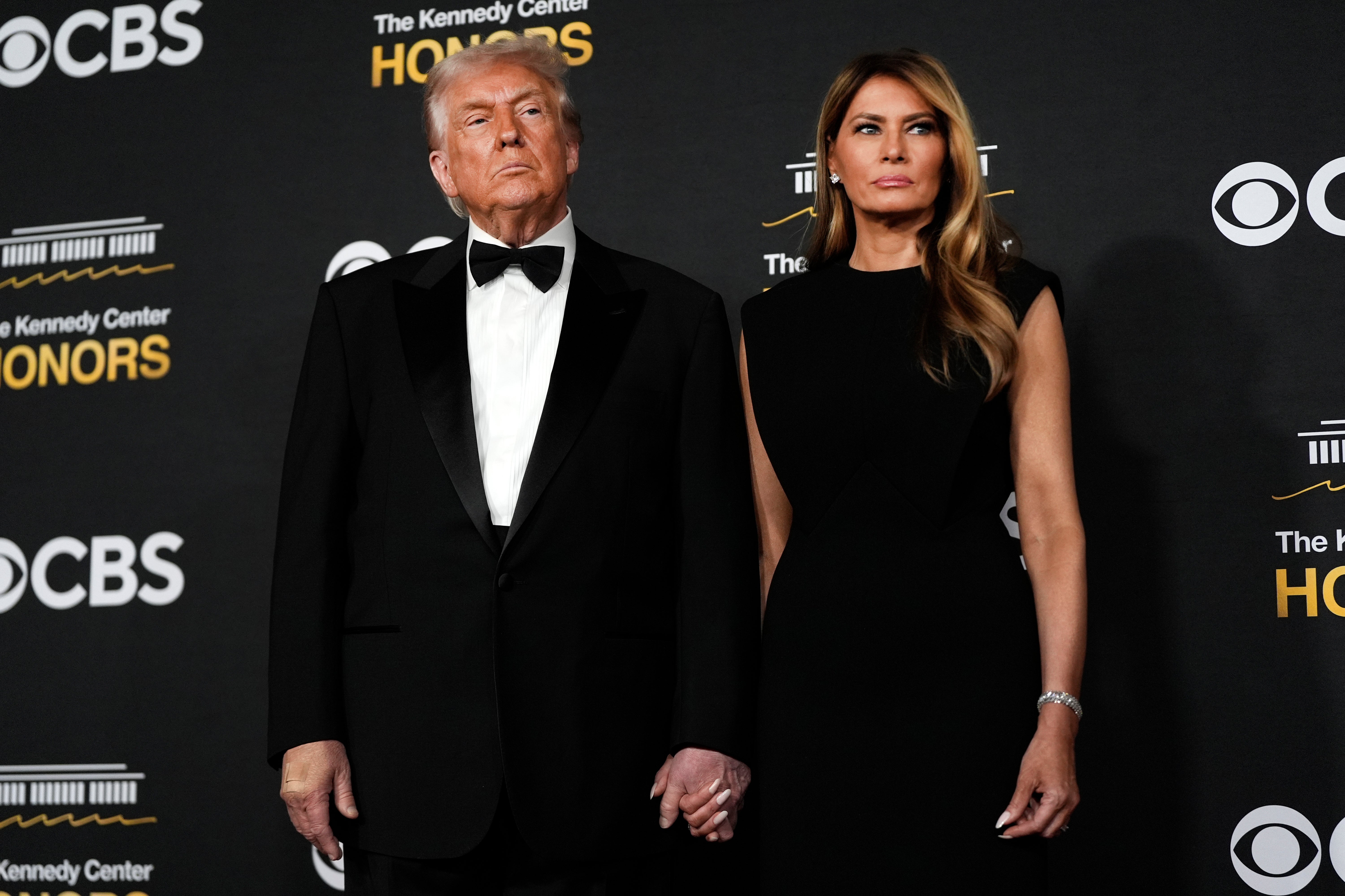 President Donald Trump and first lady Melania Trump, walk the red carpet before the 48th Kennedy Center Honors, Sunday, Dec. 7, 2025, at the John F. Kennedy Center for the Performing Arts in Washington