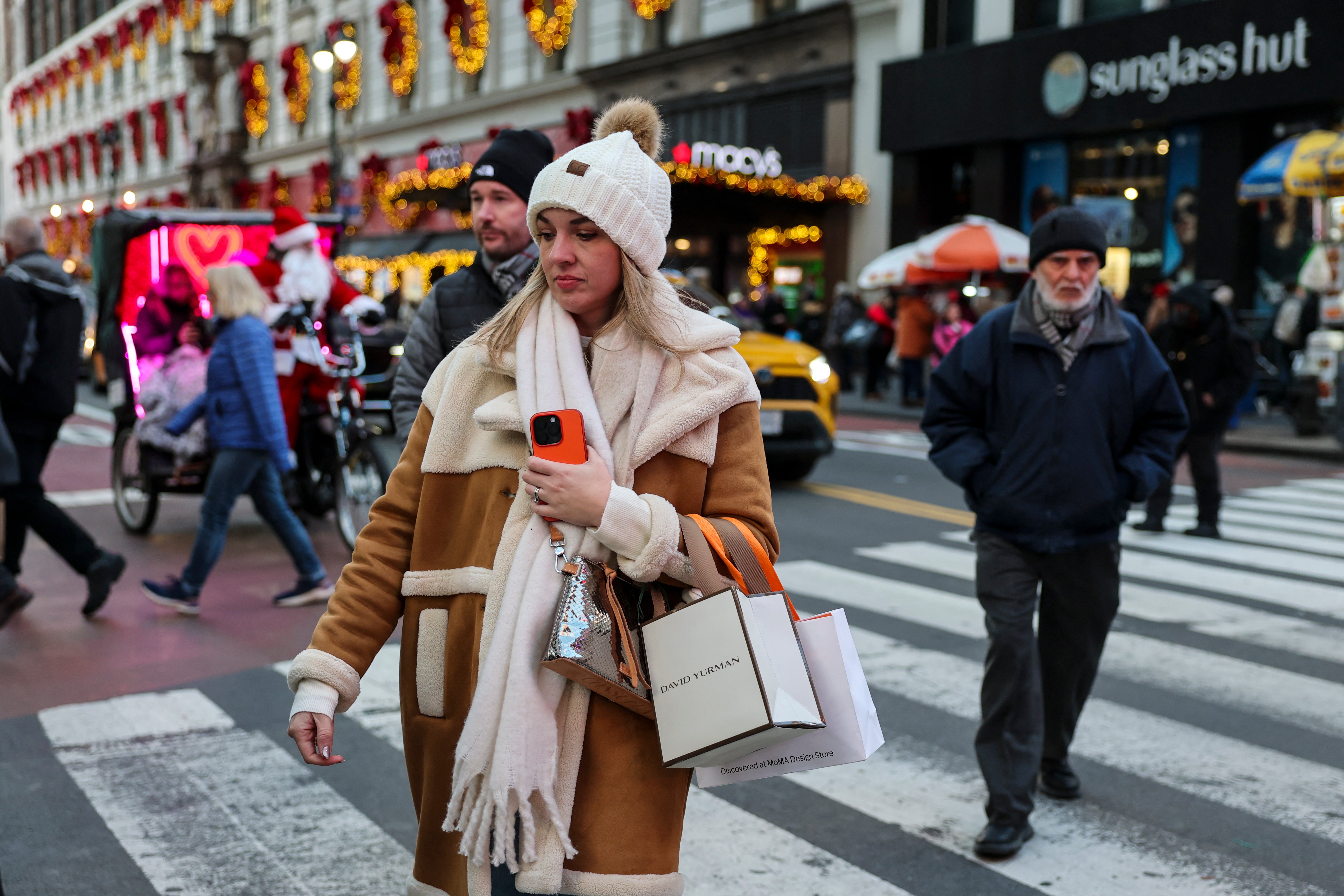 <p>A woman shops in New York City earlier this month. High stress is common this time of year</p>