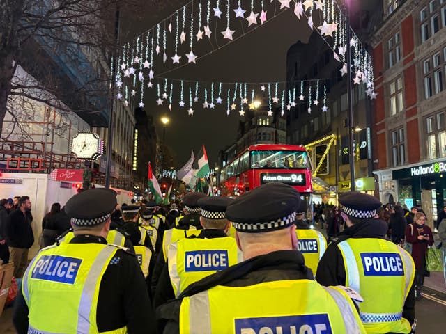 <p>Pro-Palestine protesters march down Oxford Street, London after the Met Police imposed conditions on a demonstration planned for Portland Place</p>