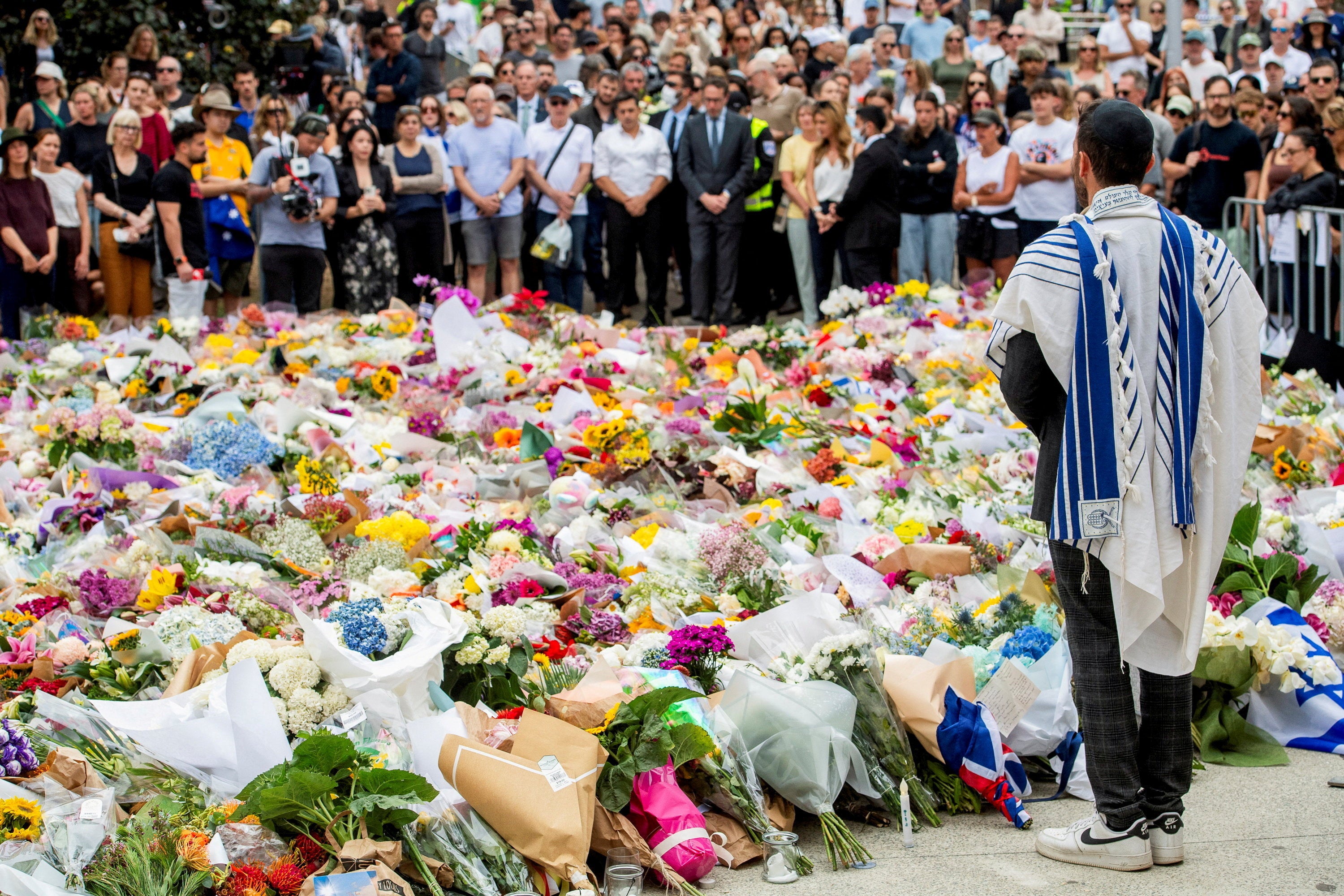 A member of the Jewish community stands at a floral memorial in honour of the victims of the mass shooting targeting a Hanukkah celebration on Sunday, at Bondi Beach, in Sydney, Australia, December 16, 2025. REUTERS/Jeremy Piper