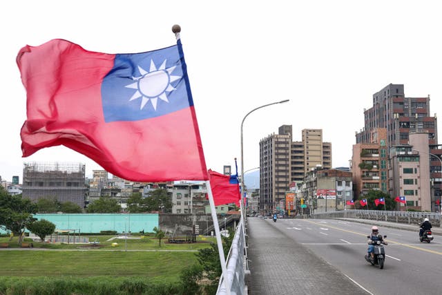 <p>Flags of Taiwan are seen on a bridge in Taipei on 18 December 2025</p>