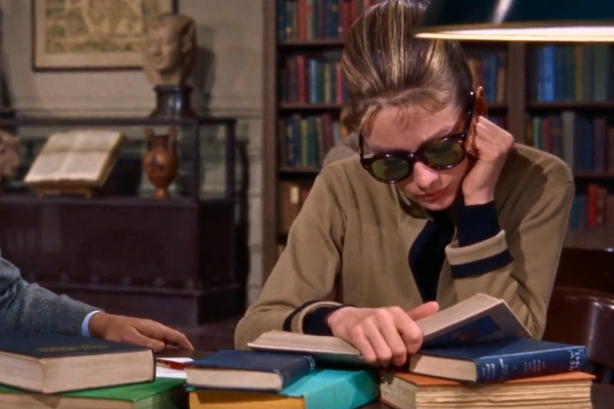 <p>Audrey Hepburn reading in New York Public Library as Holly Golightly in ‘Breakfast at Tiffany’s’ </p>