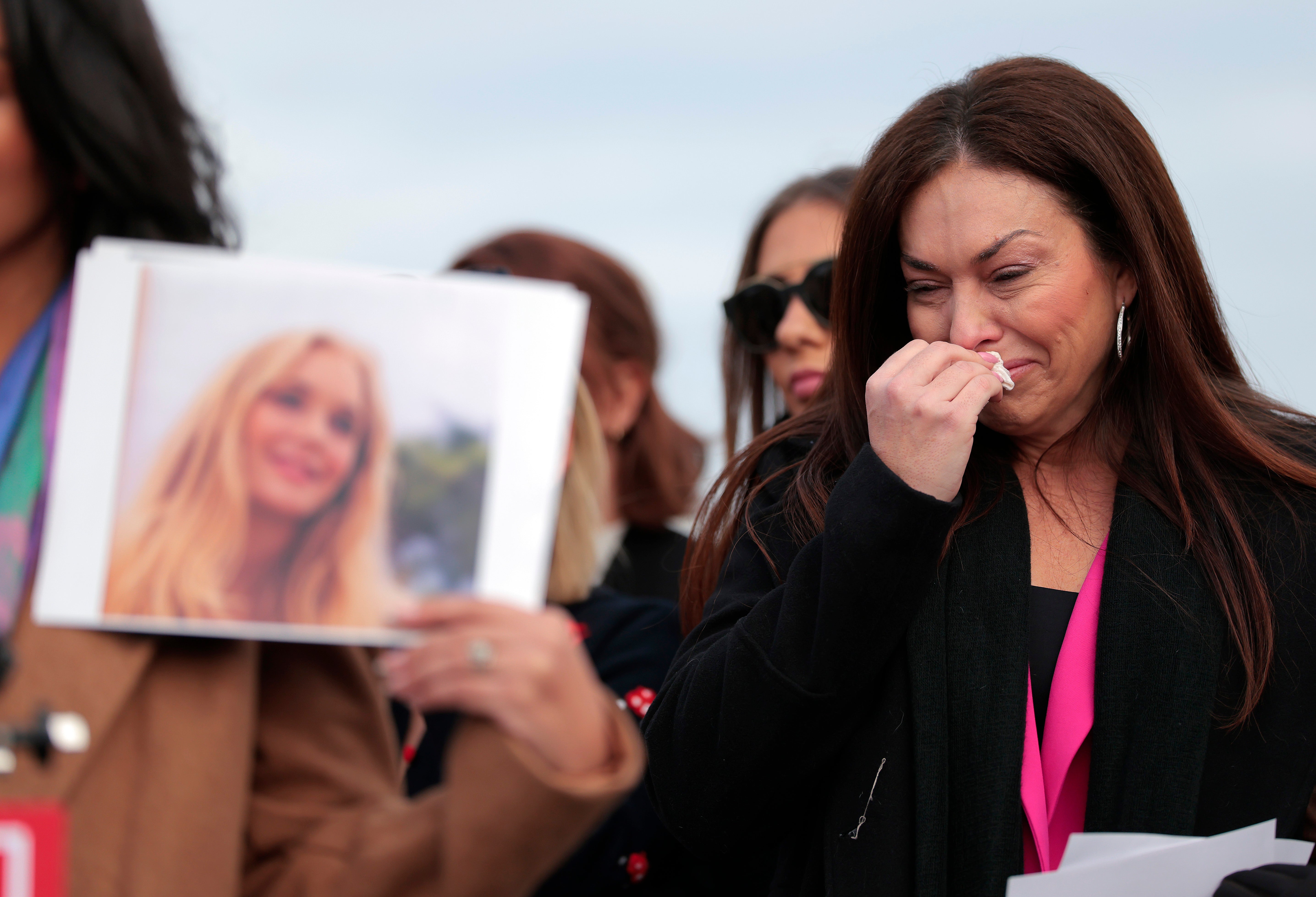 Epstein survivor Haley Robson reacts as the family of Virginia Giuffre speaks during a news conference with lawmakers on the Epstein Files Transparency Act