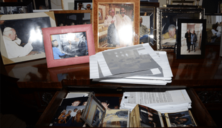 A photo of Trump, Melania and Ghislaine Maxwell is visible inside the desk drawer. Trump appeared to be in another photograph alongside a group of women. The president has not been accused of any wrongdoing.