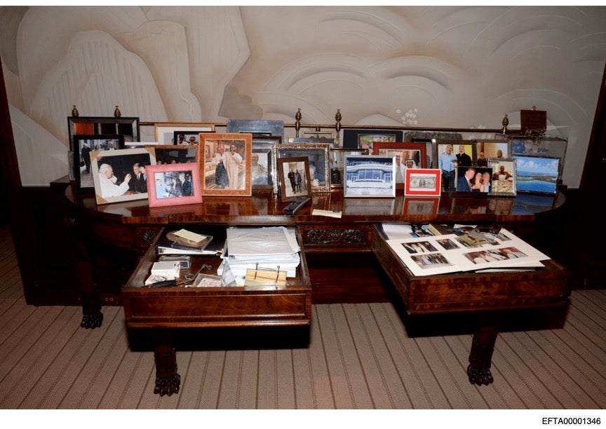 Framed photographs of President Donald Trump and the first lady Melania Trump feature in the Epstein documents released by the Justice Department (far right)