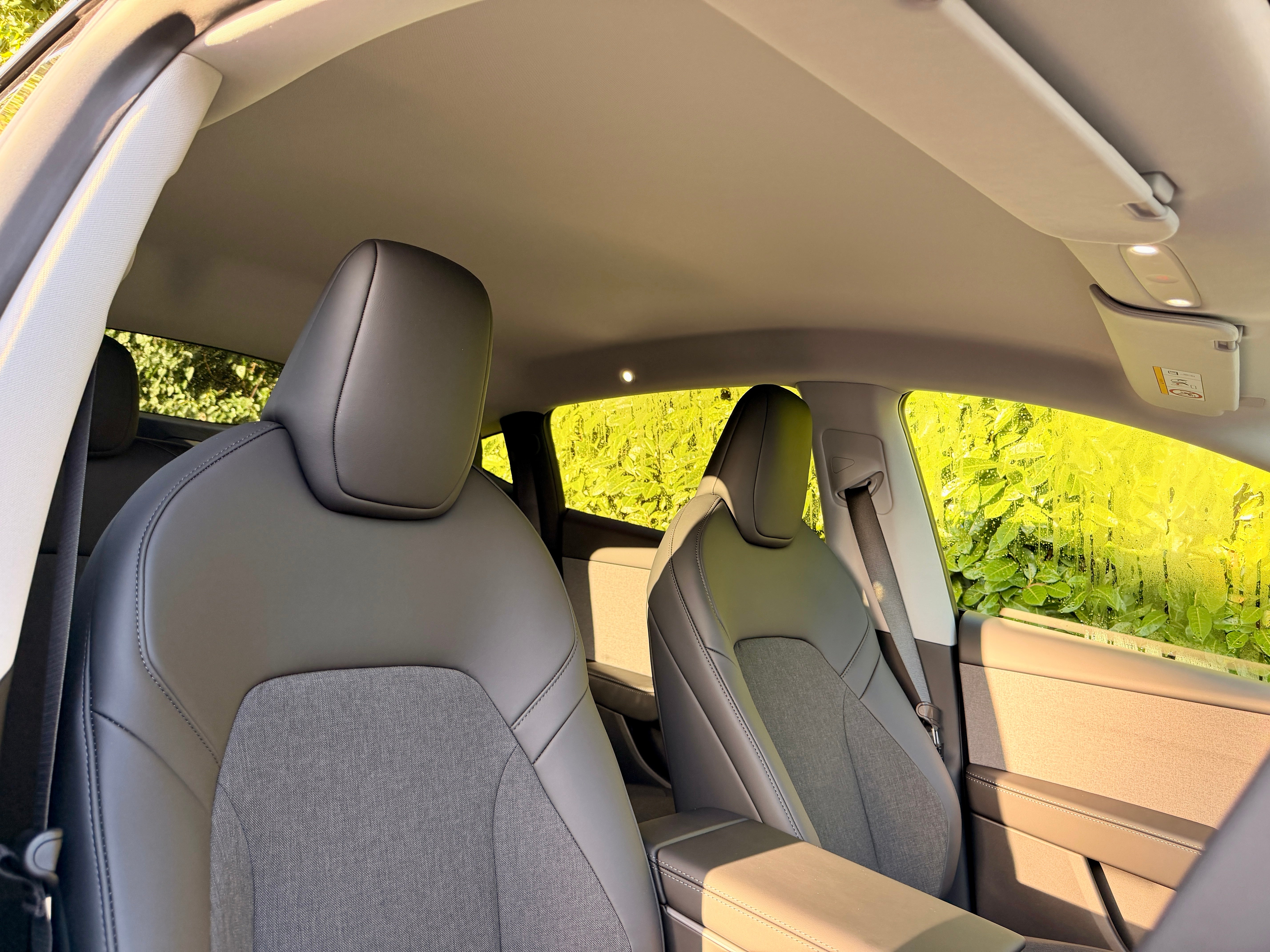 The Tesla Model Y Standard does without the glass panoramic roof and gets cloth inserts in the seats. Quality remains high