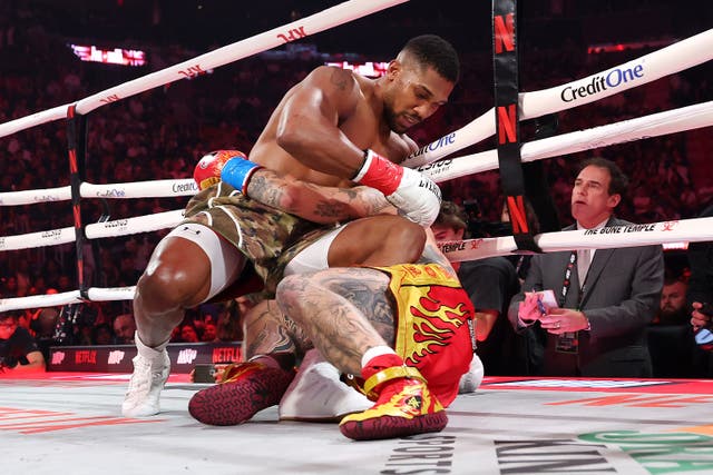 <p>Jake Paul (right) repeatedly dived at the legs of Anthony Joshua</p>