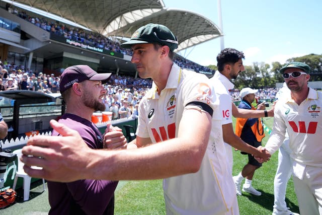 Australia’s Pat Cummins shakes hands with England head coach Brendon McCullum (Robbie Stephenson/PA)