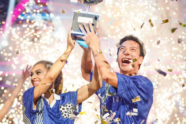 Karen Carney and Carlos Gu with their trophy after winning the 2025 series of Strictly Come Dancing (Guy Levy/BBC)