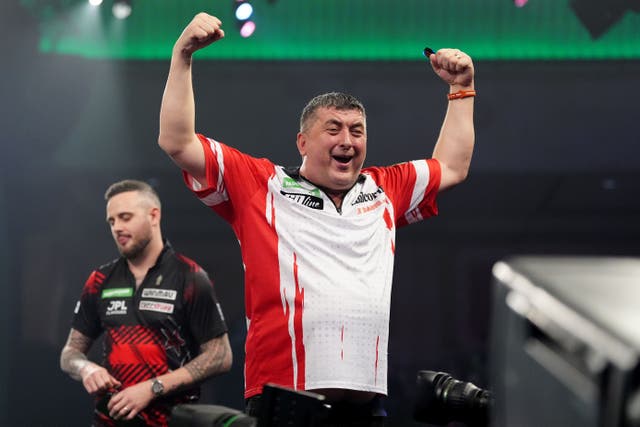 Mensur Suljovic celebrates after defeating Joe Cullen at Alexandra Palace (Bradley Collyer/PA)