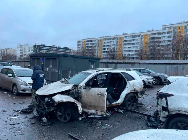 <p>An investigator working at the scene in Moscow where Lt Gen Fanil Sarvarov was killed by an explosive device planted under his car </p>