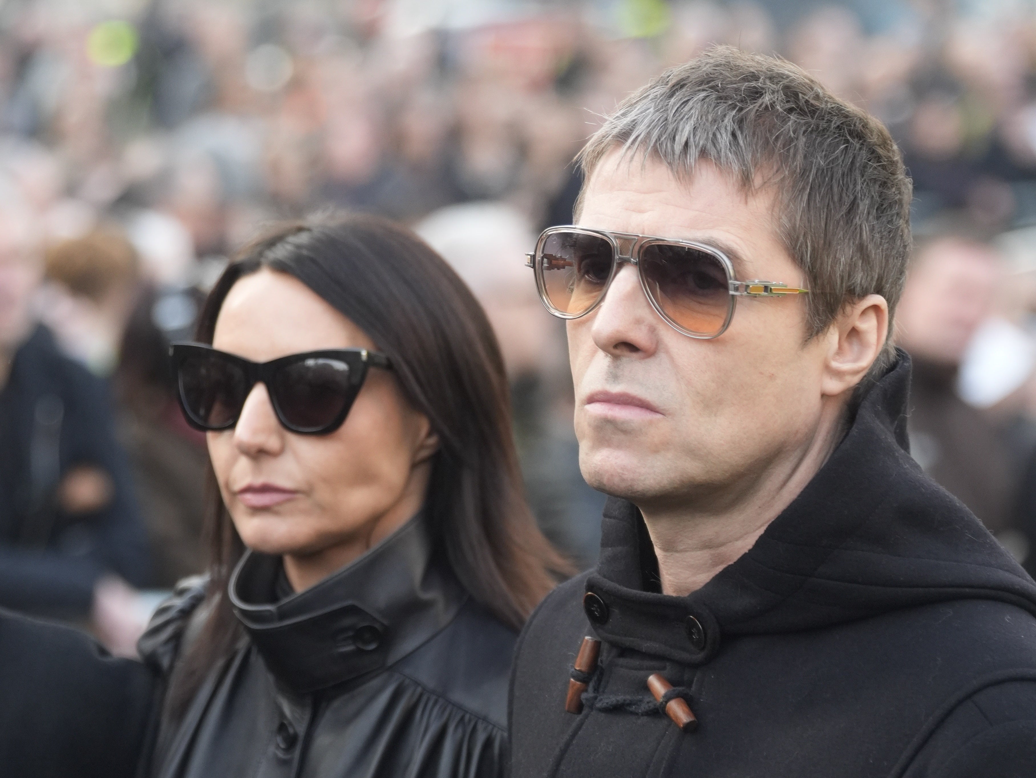 Liam Gallagher and his partner Debbie Gwyther arriving for the funeral service of former Stone Roses and Primal Scream bass player Gary Mounfield