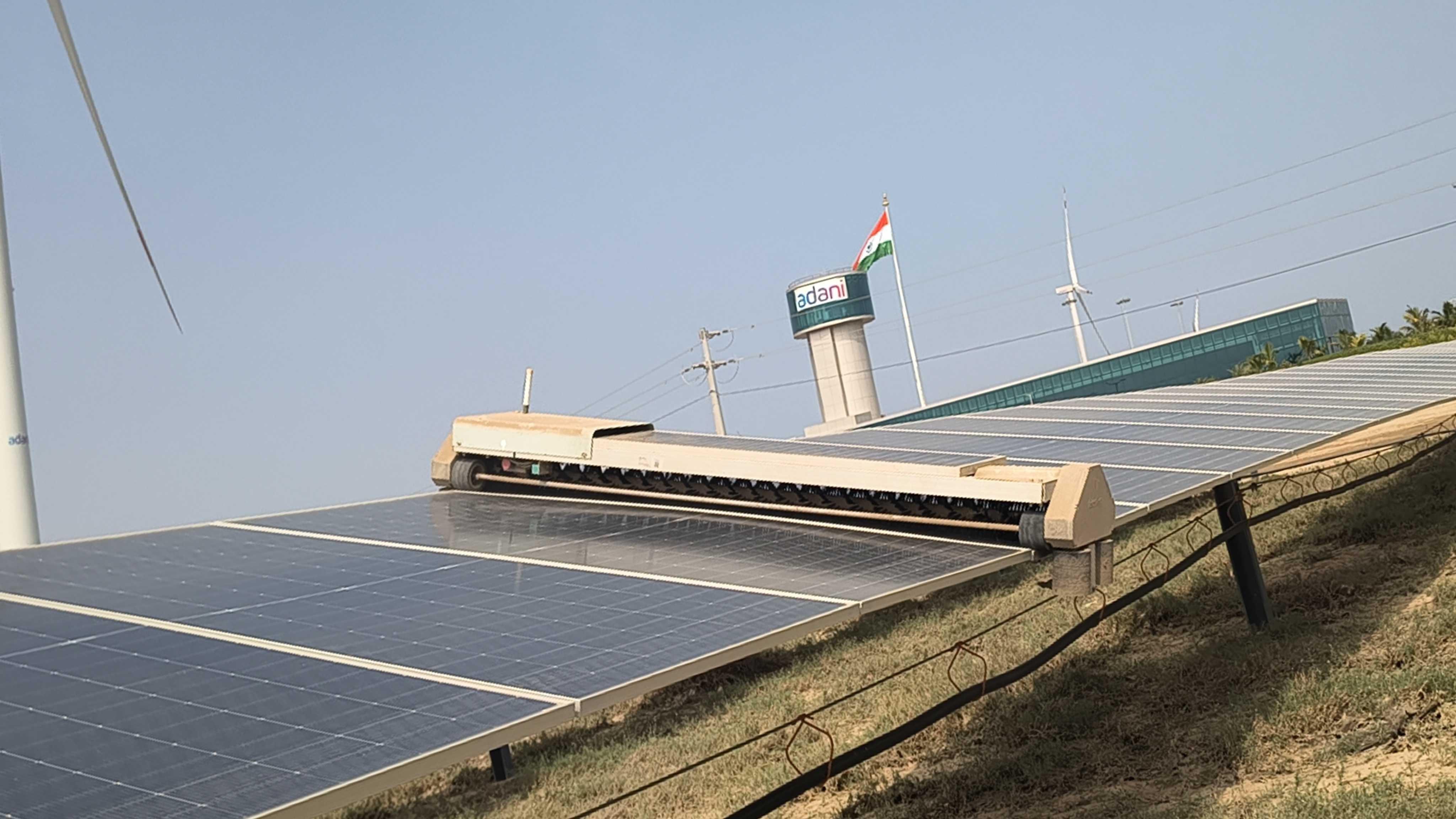 A solar panel is cleaned by a robot at Khavda