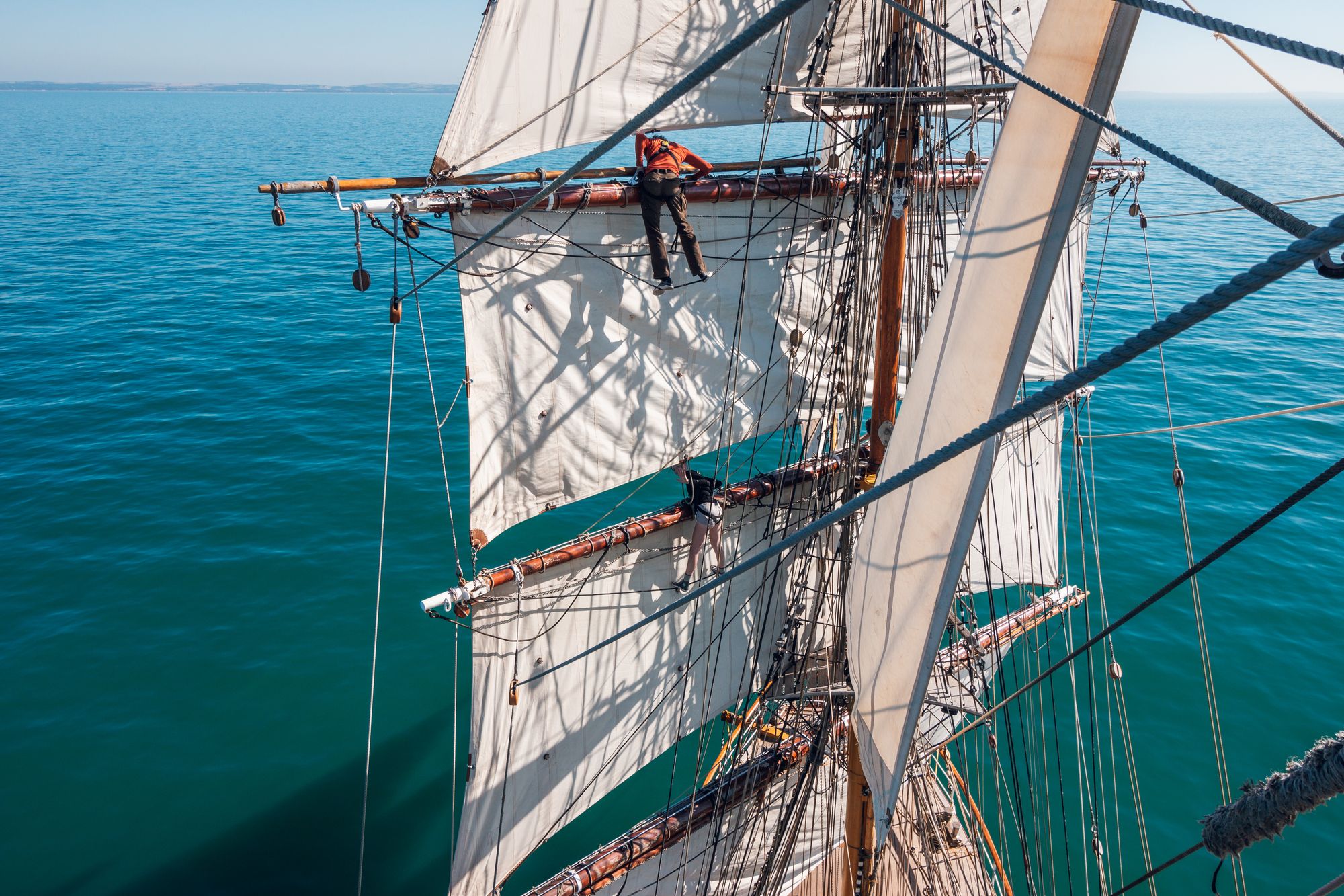Passengers can climb the sails of the Bark Europa cruise ship during a Chilean Channels sailing