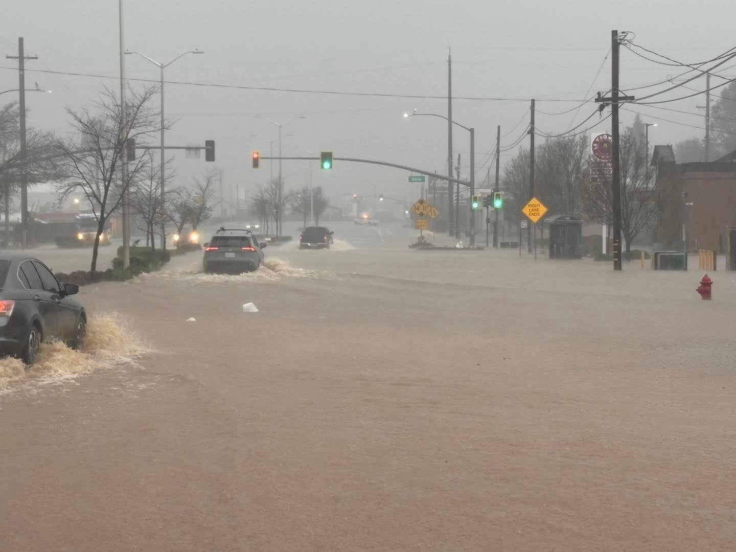 A picture shows dirty floodwaters filling the streets of Northern California's Redding community