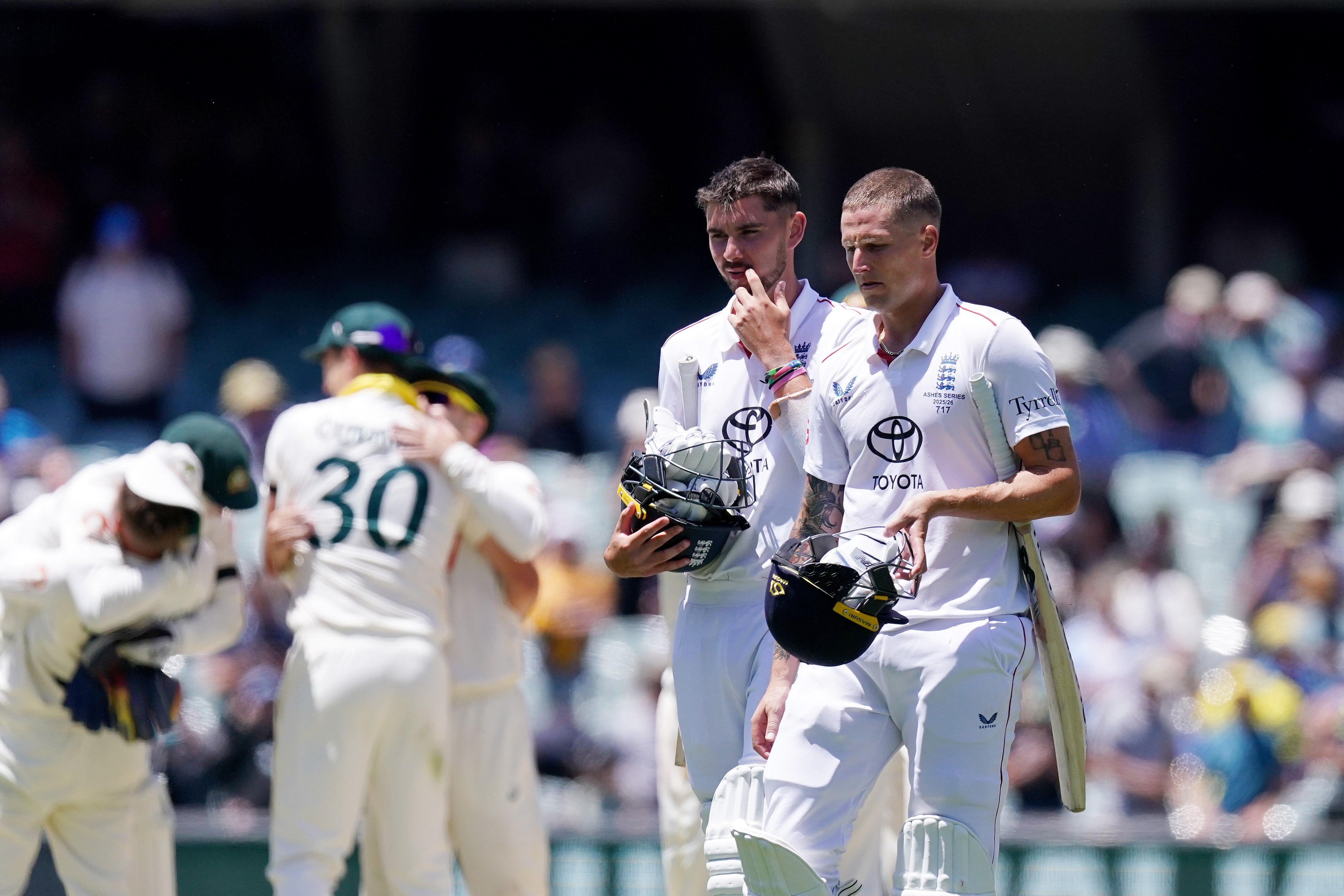 England’s Josh Tongue (left) and Brydon Carse (right) walk off the field after defeat on day five of the third Ashes Test in Adelaide (Robbie Stephenson/PA)