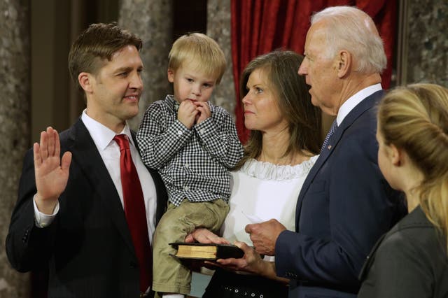 <p>Former Sen. Ben Sasse seen with his family in 2015 as he was ceremonially sworn in by U.S. Vice President Joe Biden</p>