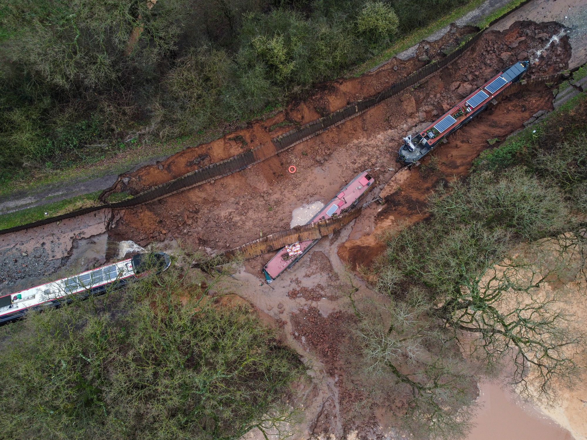 Ten people have been helped to safety after a 50-metre-long sinkhole breached a canal in Shropshire, leaving several narrow boats stranded.