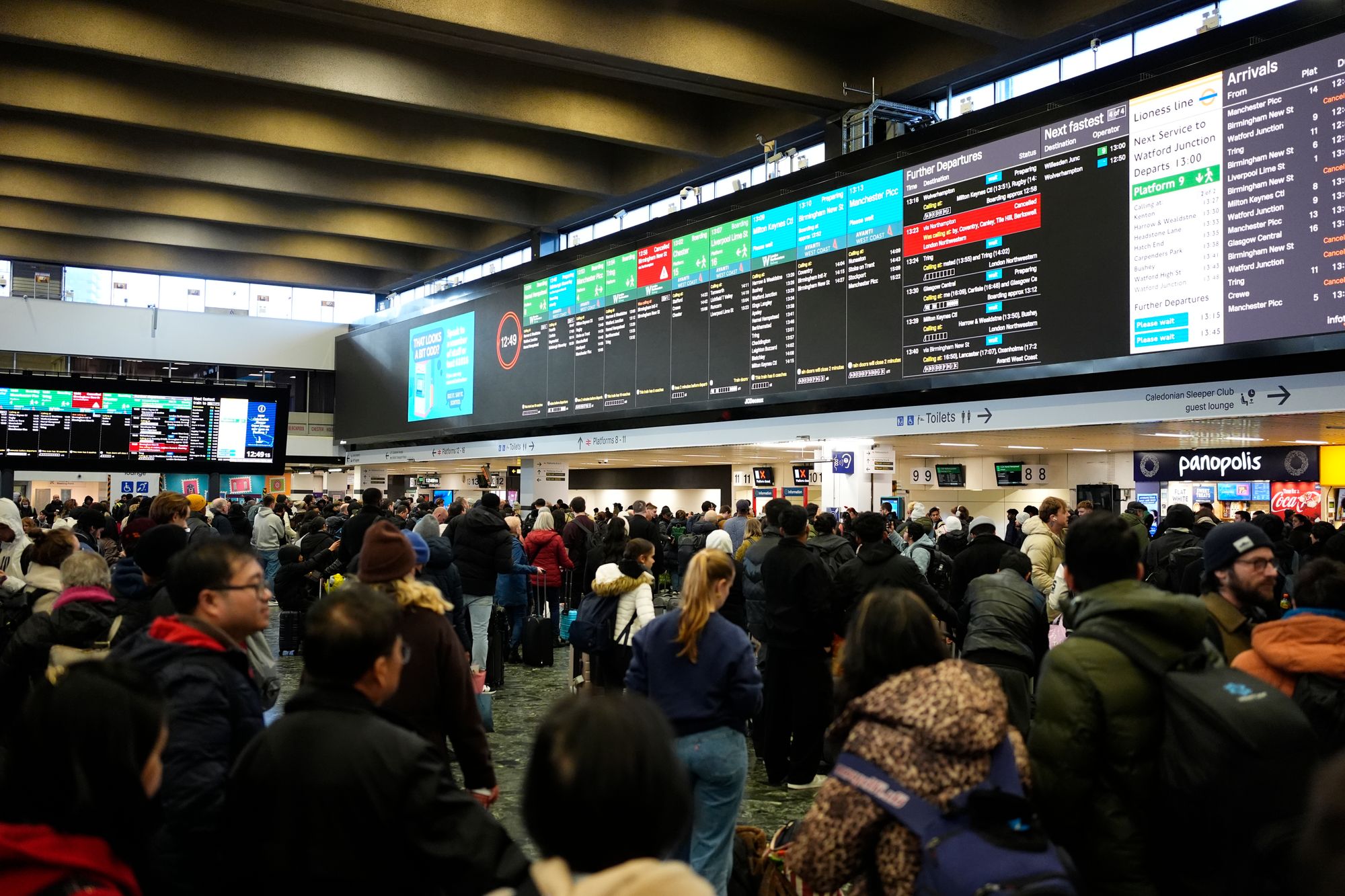 <p>Travellers on Christmas Eve at Euston train station in London</p>