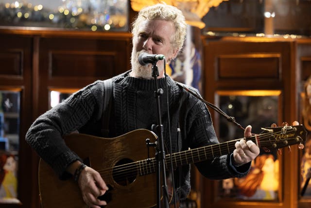 Glen Hansard takes part in the annual Christmas Eve busk on Grafton Street (Conor O Mearain/PA)