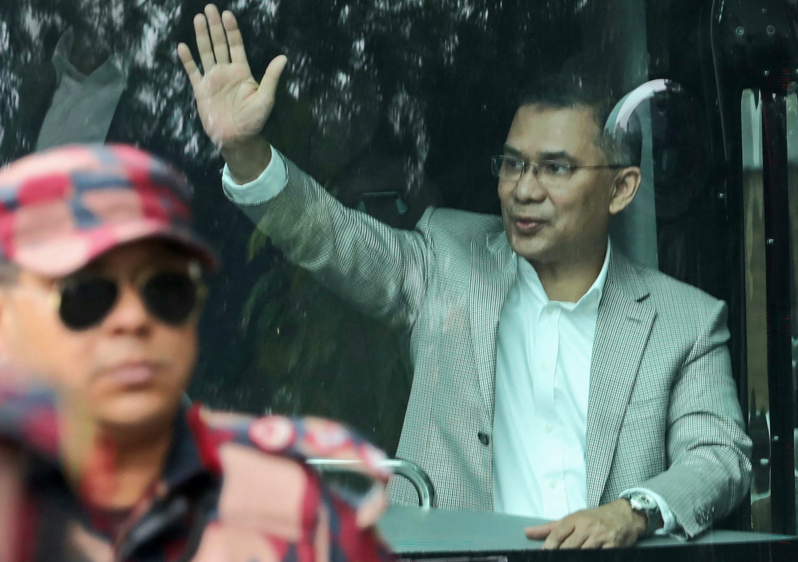 Acting chairman of the Bangladesh Nationalist Party Tarique Rahman waves to supporters from a bus upon his arrival in Dhaka on 25 December 2025