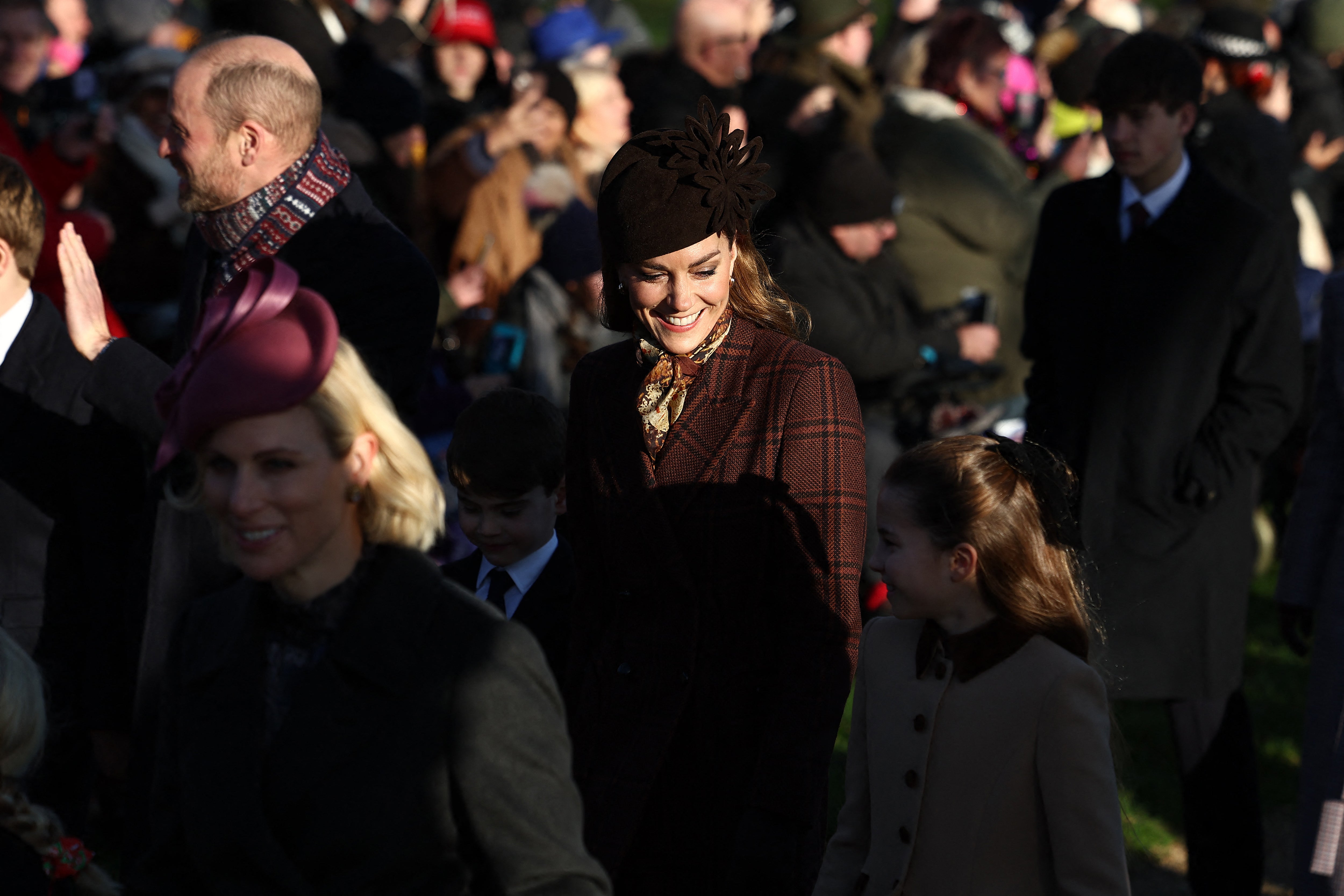 Catherine, Princess of Wales (C), holds hands with Prince Louis (L) and Princess Charlotte