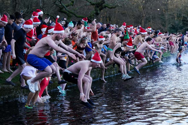 Swimmers take a Christmas Day dip in Blackroot Pool at Sutton Park, in Sutton Coldfield, Birmingham (Jacob King/PA)