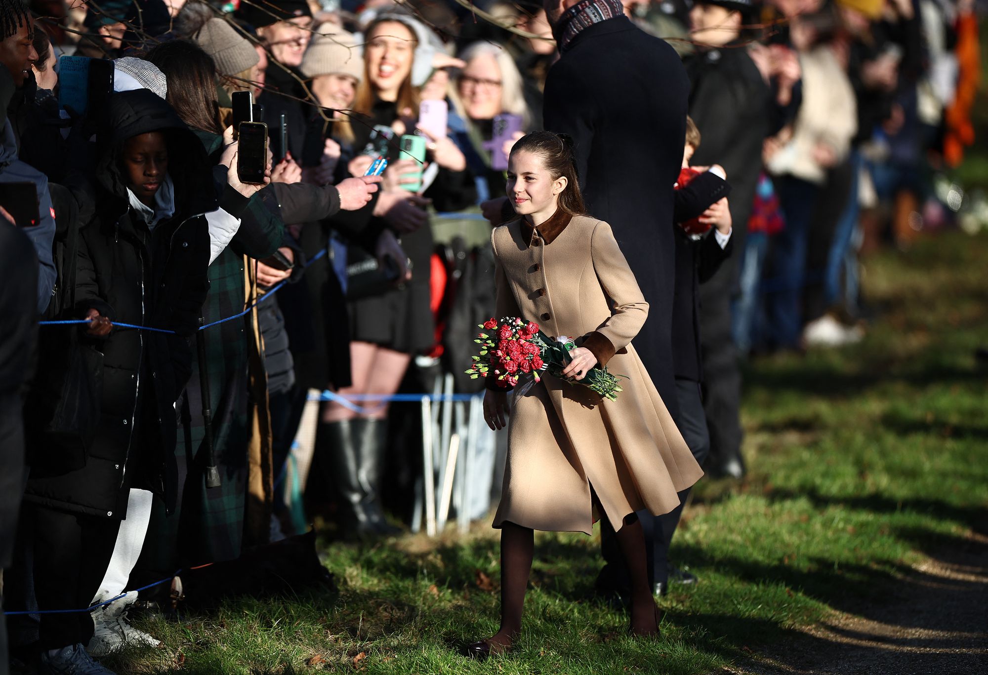 Princess Charlotte clutched a bouquet of flowers in her arms as she greeted crowds in Norfolk