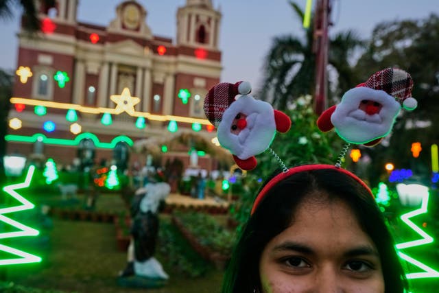 <p>A girl poses for a picture at the Sacred Heart Cathedral on Christmas Eve in Delhi, India</p>