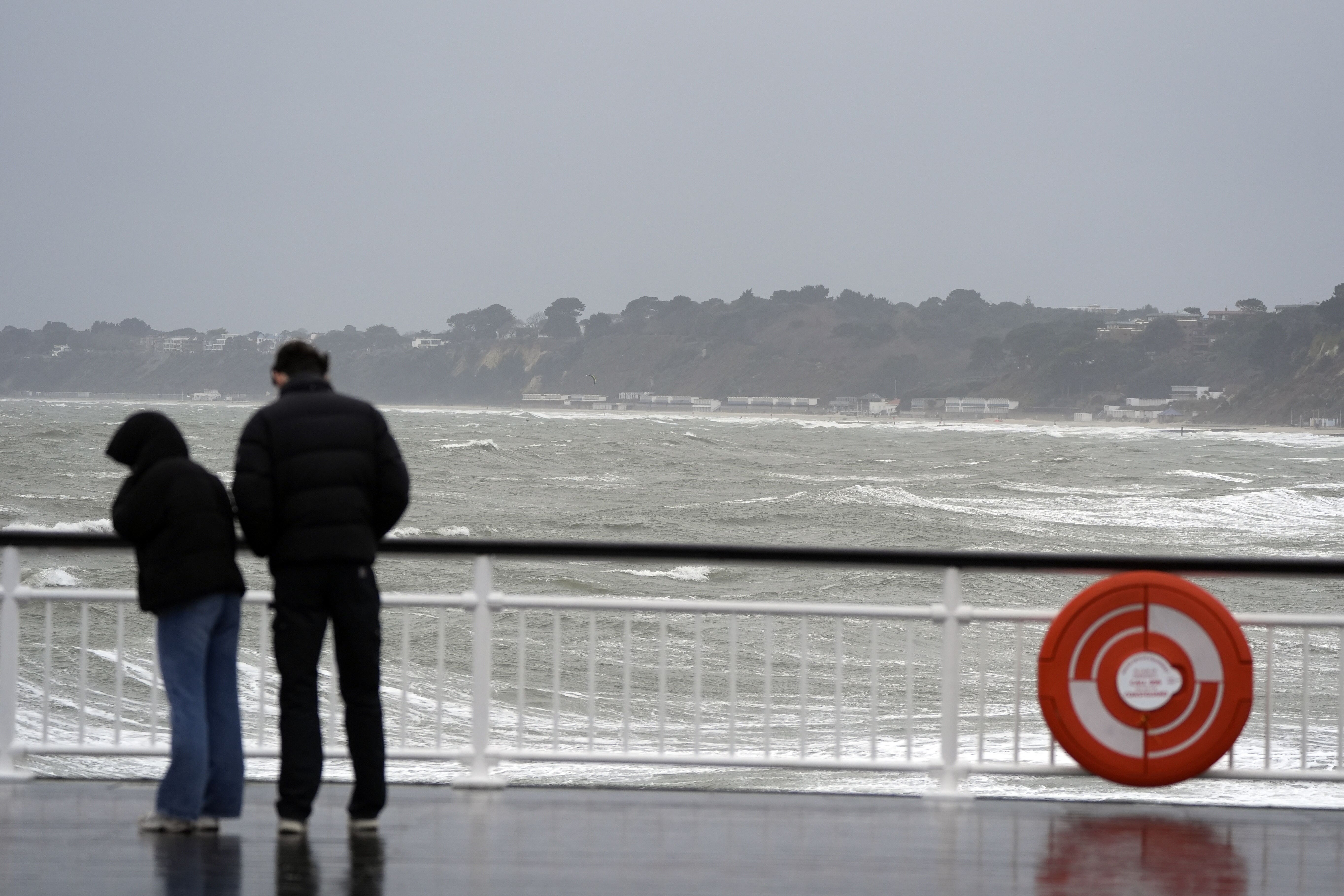 People on Bournemouth Pier as the wind blows in (Andrew Matthews/PA)