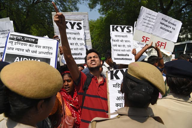 <p>Indian activists and students hold placards and shout slogans during a protest against the alleged political silence over rape cases in Jammu and Uttar on 12 April 2018</p>